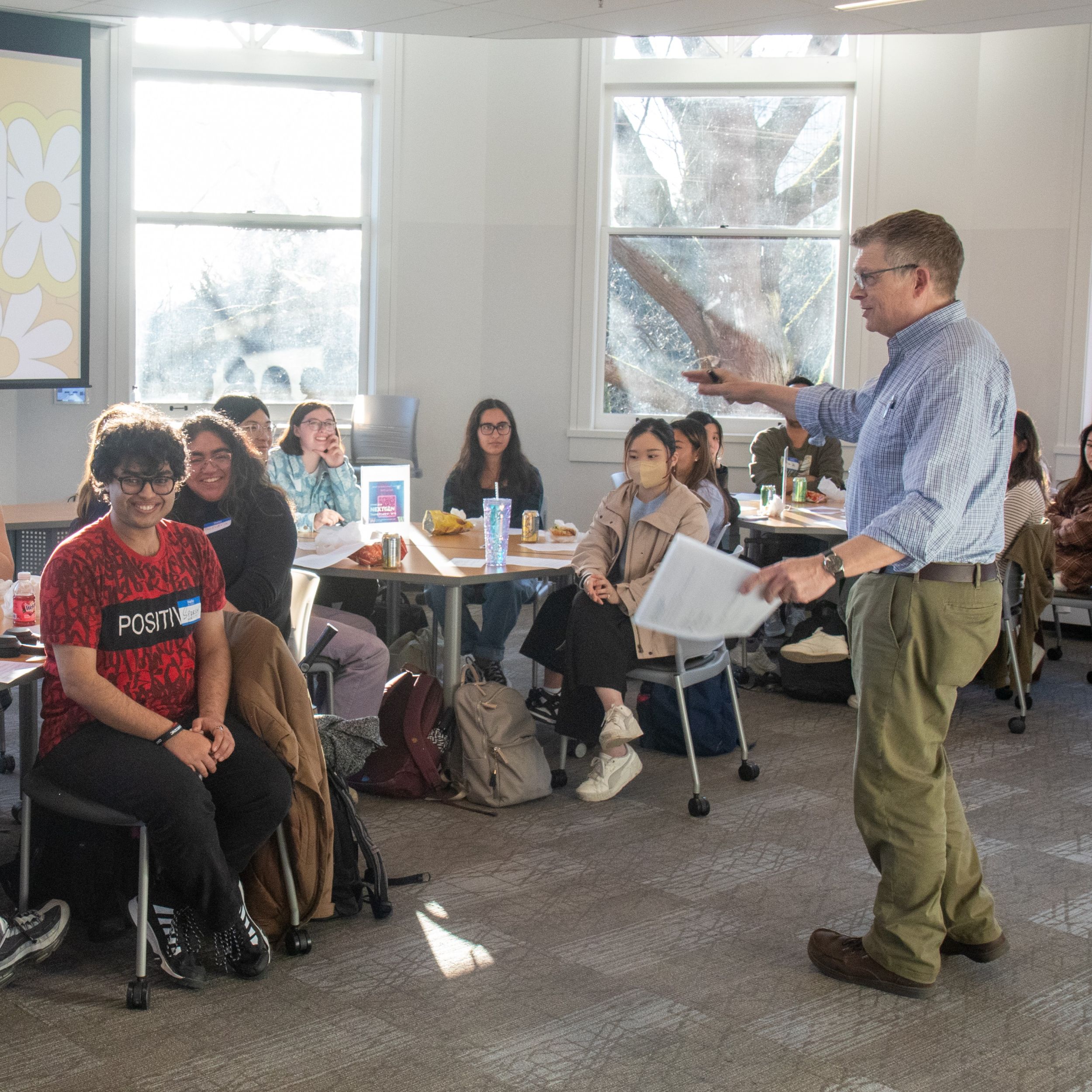 An instructor speaks to a class of students