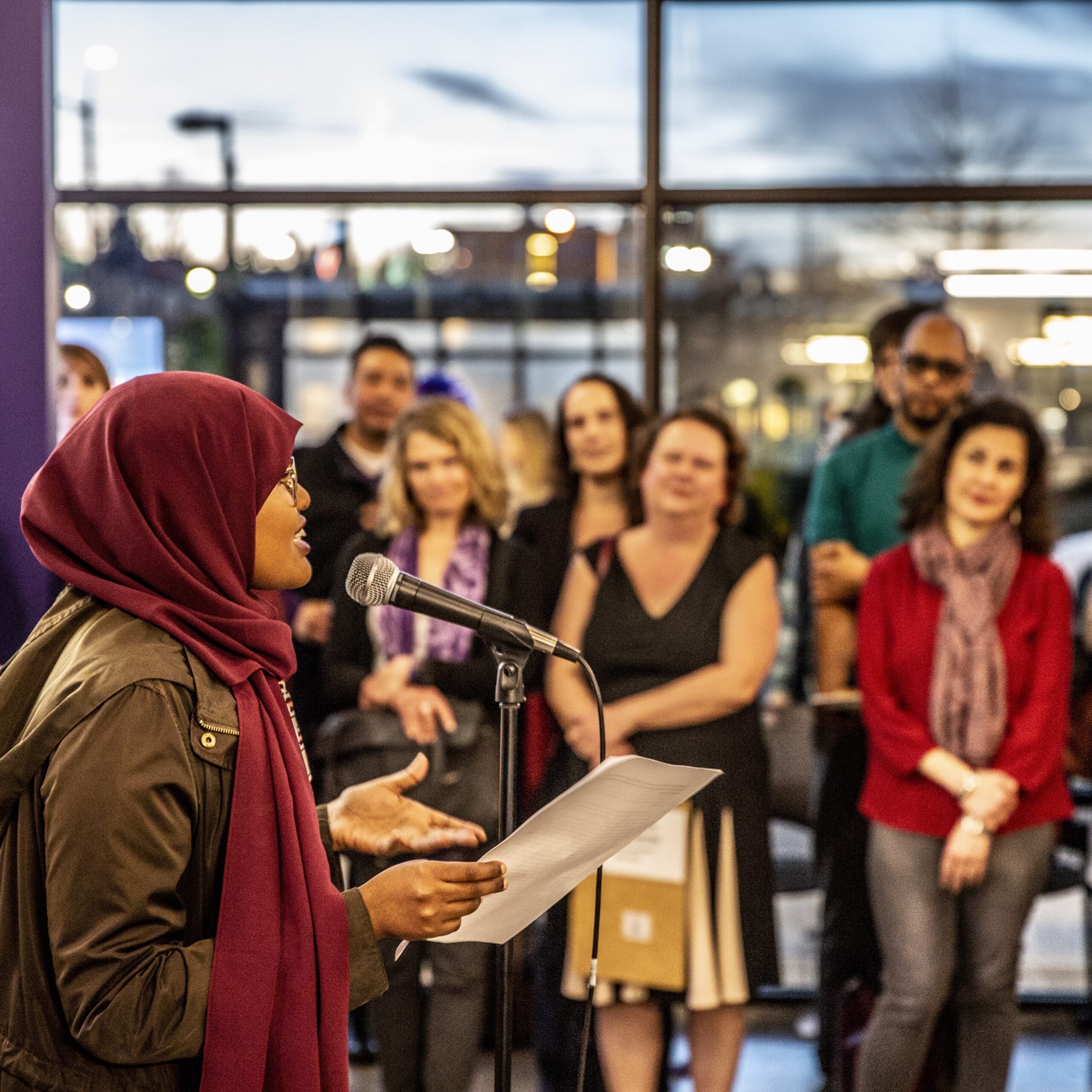 A woman addresses the audience at an event.
