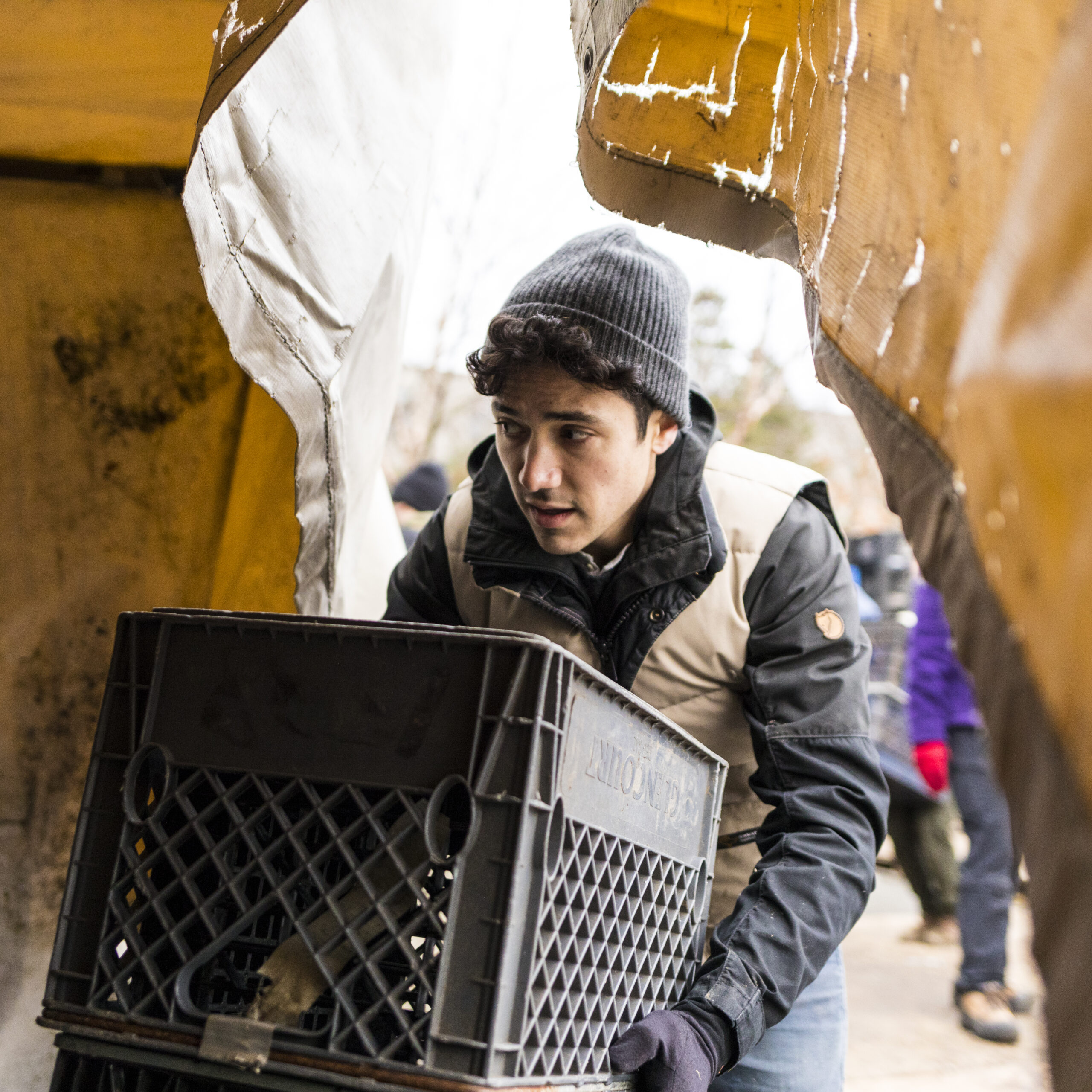 A Tent City resident carries personal belongings