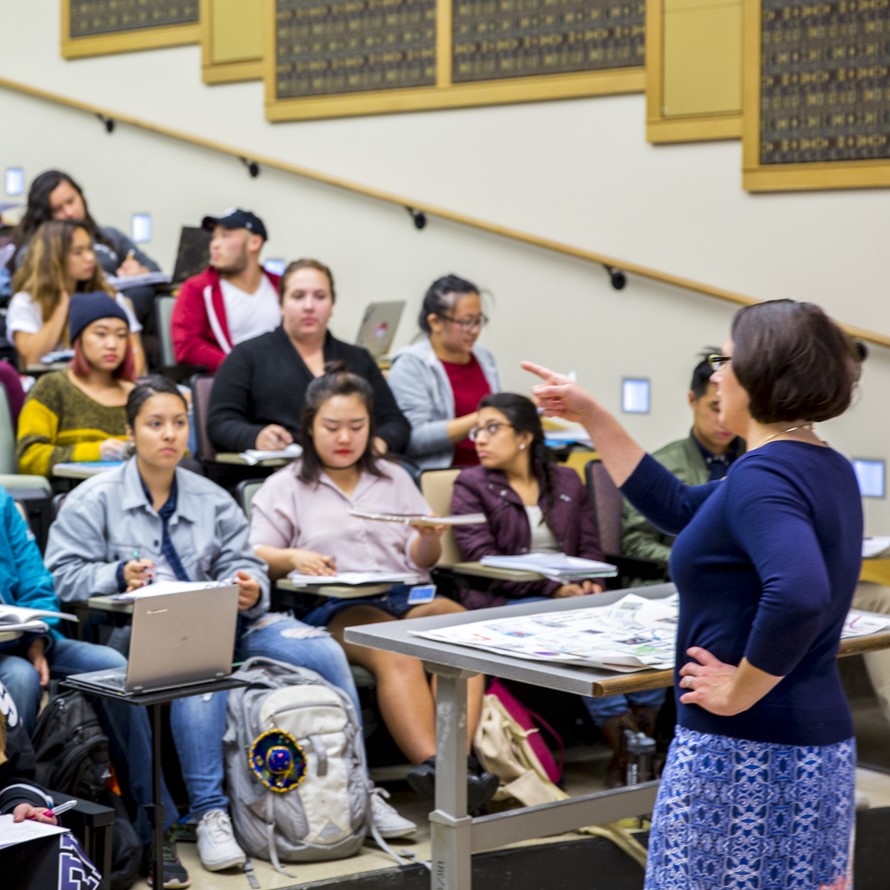 An instructor engages with students in a classroom setting