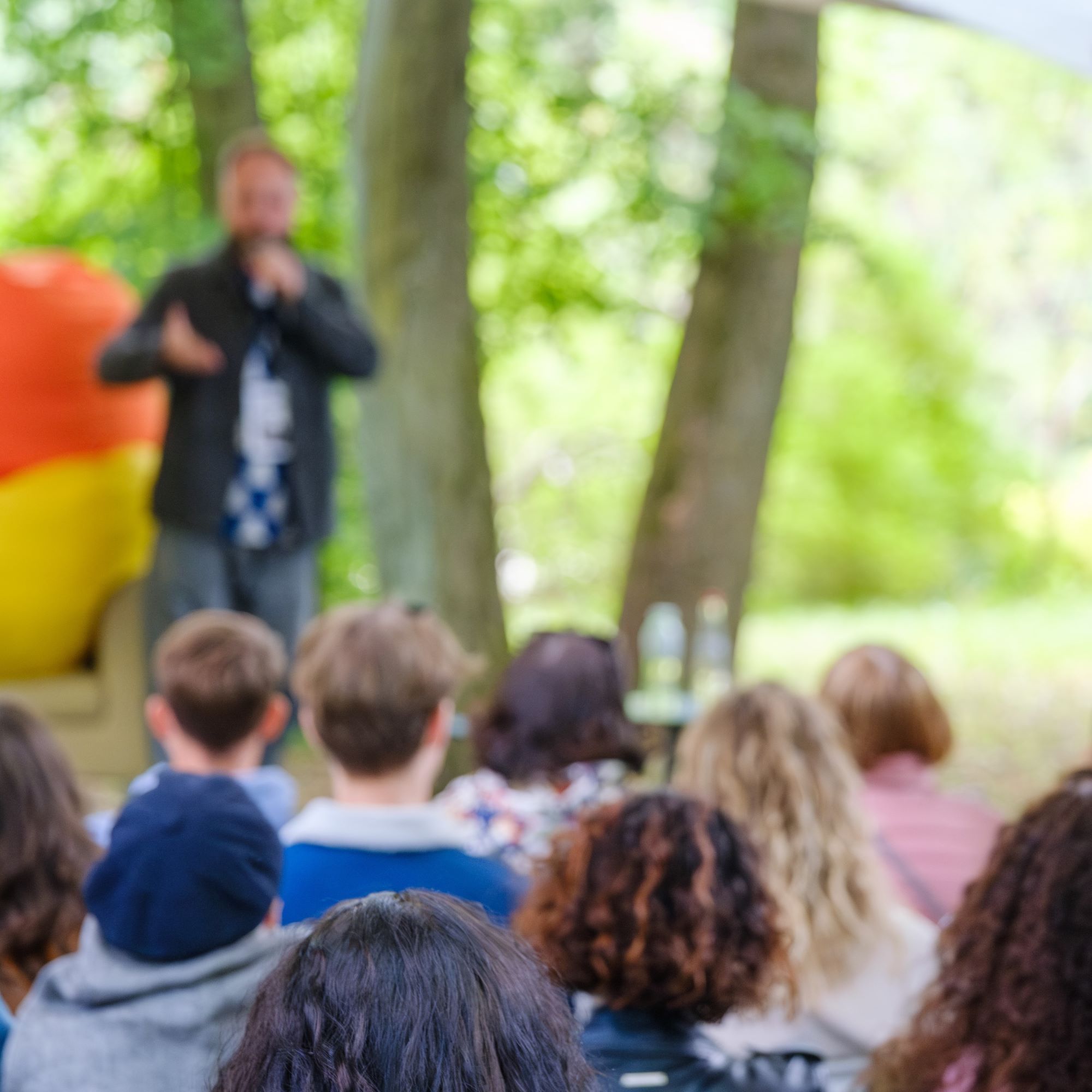 Audience engages with a speaker in an outdoor setting