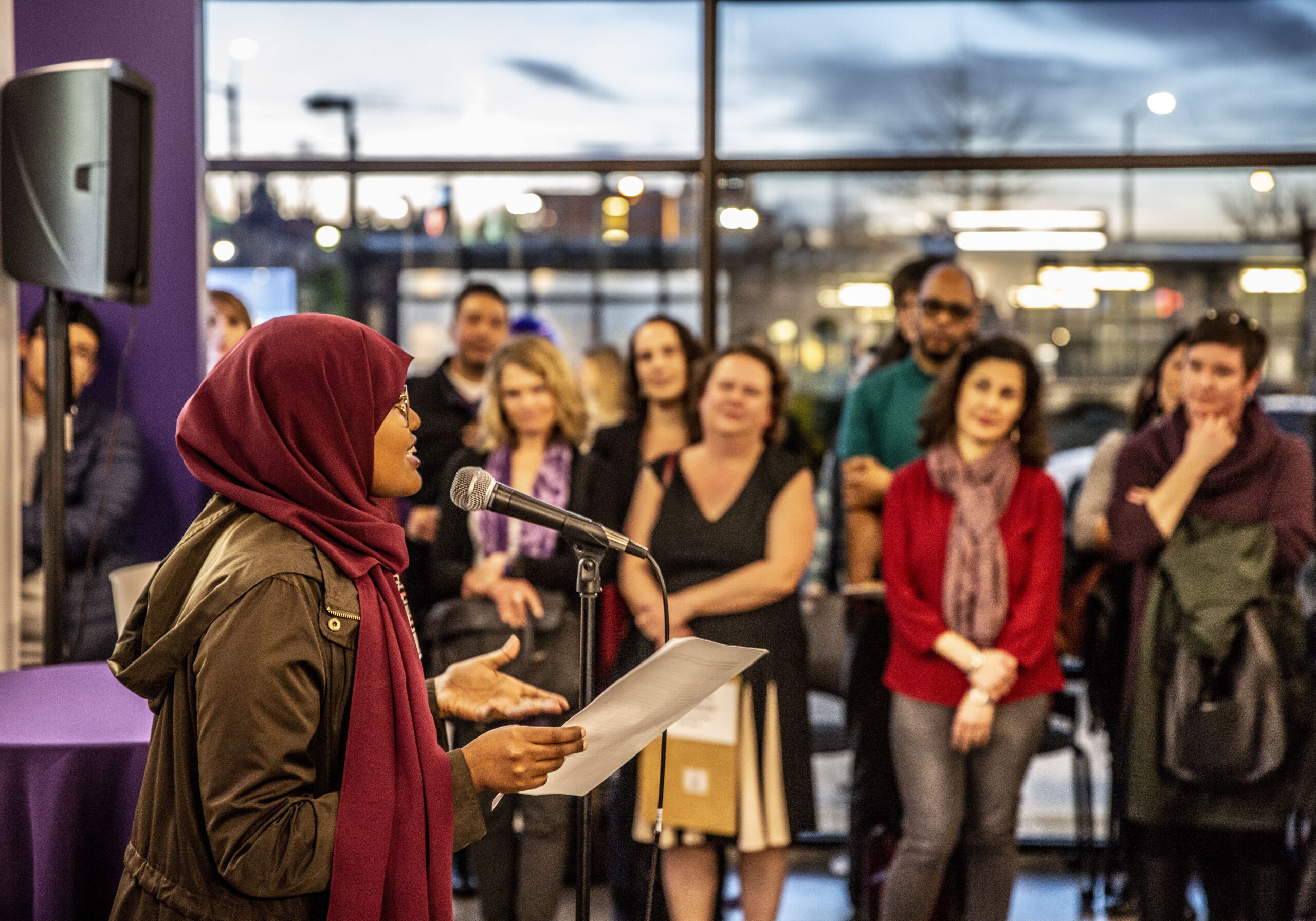 A student speaks to a group of people